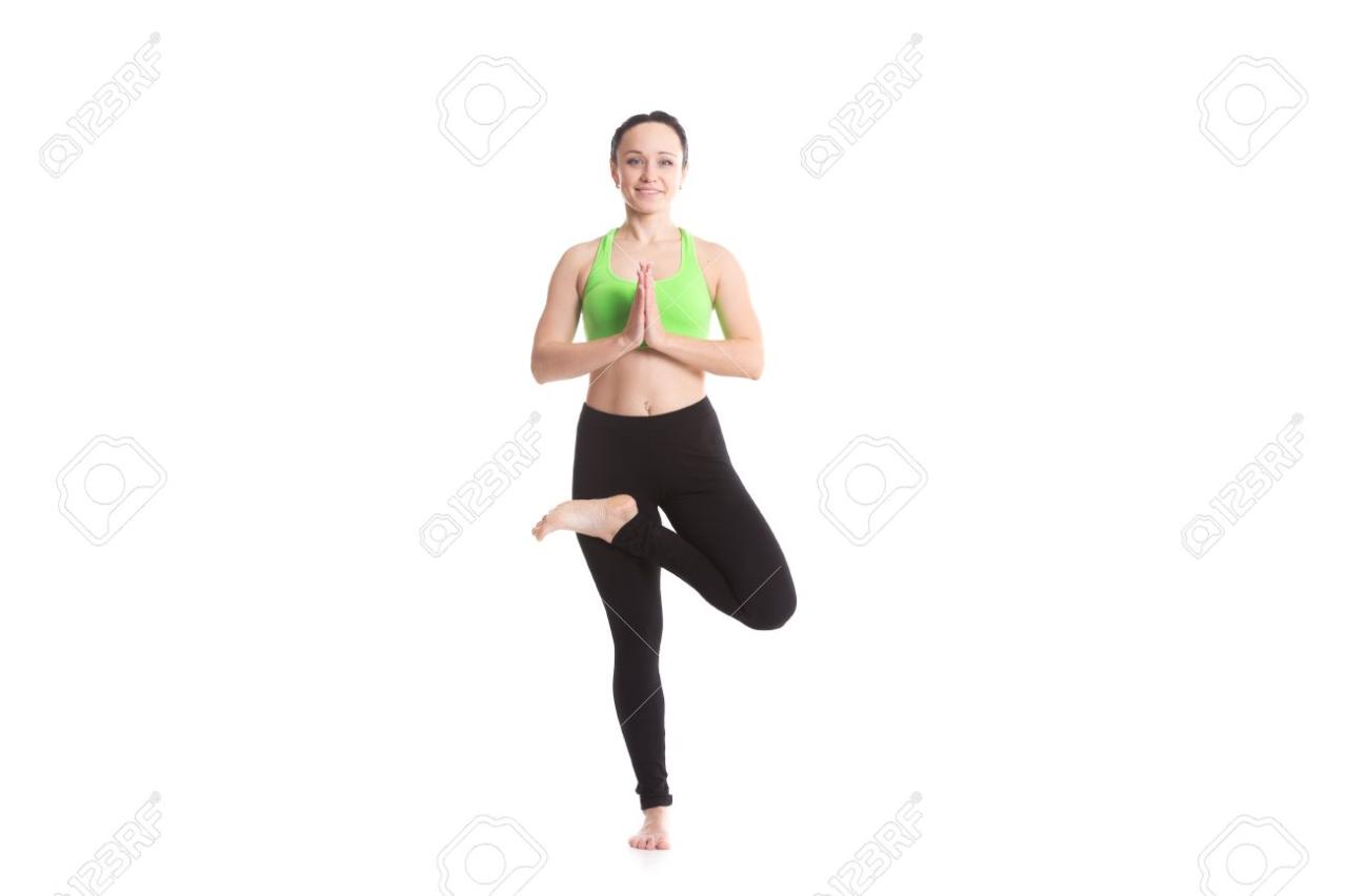 Smiling Slender Girl On White Background Doing Exercise For Spine, Standing  In Tree Pose, Asana Vrikshasana, Vriksasana, Leg In Half Lotus Position,  Yoga For Stress Stock Photo, Picture And Royalty Free Image.